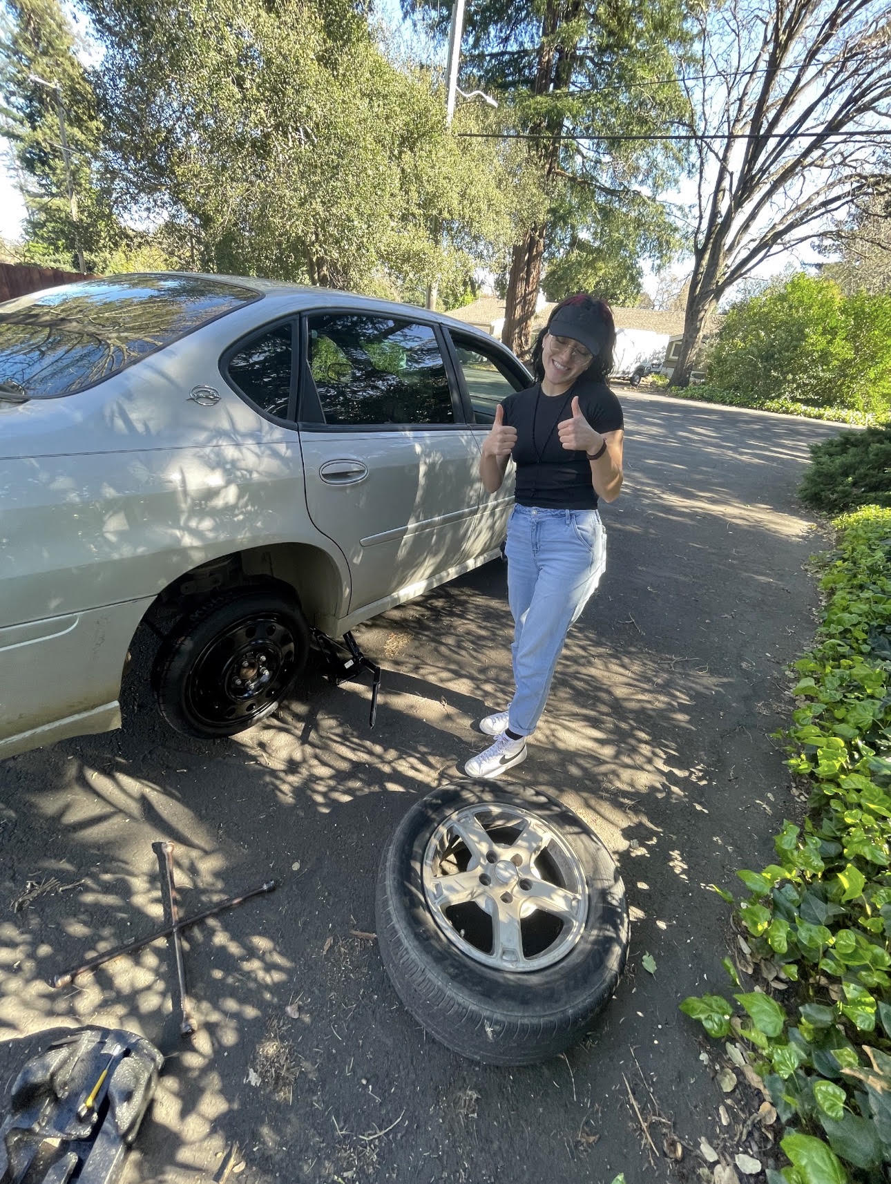 Azhley helping change to a spare tire after it blew up on the freeway for an ungateful monster